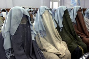 Afghan women, putting blue scarves that symbolizes justice on their h